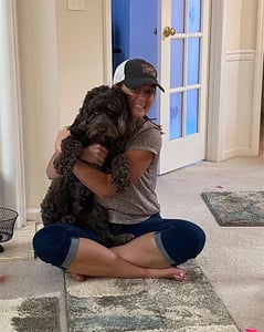 Young lady enjoying time with her Australian Labradoodle